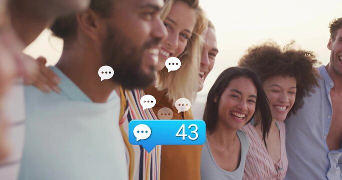 Smiling eight friends leaning in at sunset pier railing, chat bubbles with blue notification 43 - Powered by Adobe