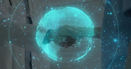 Hovering holographic globe rotating in office, showing lab coat and suit shaking hands