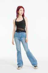 Fototapeta premium Asian confident young woman purple short hair standing posing wearing black sleeveless top blue jeans on white background in studio modern street outfit fashion portrait casual attitude trendy style.