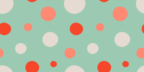 Playful Christmas background with large polka dots in red, white, and mint tones. Simple geometric festive pattern for seasonal design and wrapping