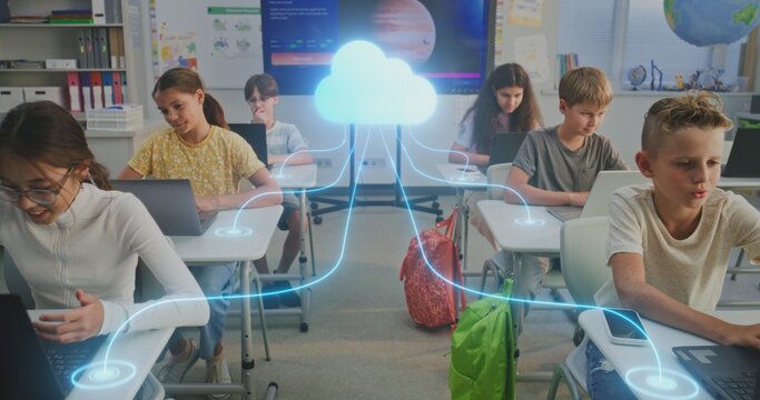 Kids Connected Cloud in Digital Classroom. Diverse Pupils Work on Laptops Connected to Cloud by Glowing Digital Lines. Cloud Technology, Networked Learning, Technology Education of Future. Dolly Shot.