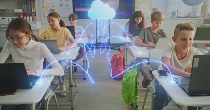 Kids Connected Cloud in Digital Classroom. Diverse Pupils Work on Laptops Connected to Cloud by Glowing Digital Lines. Cloud Technology, Networked Learning, Technology Education of Future. Dolly Shot. - Powered by Adobe