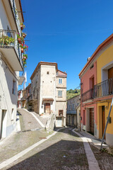 Obraz premium A narrow street among the old houses of Casalbuono, a village in the province of Salerno, Italy.