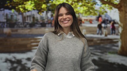 Woman smiling outdoors on a city street with bright autumn leaves in the background showcasing a cheerful and relaxed atmosphere. - Powered by Adobe