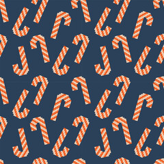 Festive vector illustration of seamless candy cane pattern featuring red and white striped candy canes on a dark blue background.