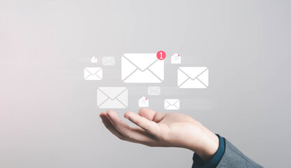 Business hand receiving new email notification icon, concept of online communication, digital marketing, message inbox, technology connection for modern office work touching virtual email icon with