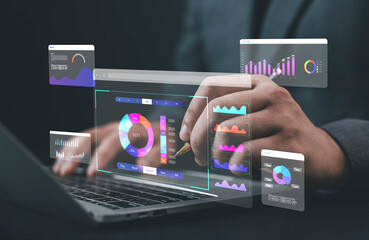 Businessman analyzing digital data chart on laptop, concept of big data analytics, business intelligence, marketing performance, financial dashboard, and data visualization technology.