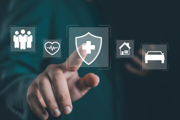 Businessman touching digital insurance icon, concept of health protection, life coverage, medical service, home and car insurance, and secure online financial technology.