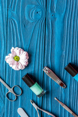 nail polish and spa manicure set on dark wooden background
