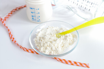 preparation of mixture baby feeding on white background