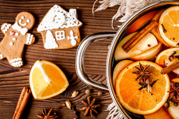 preparation of mulled wine in pot wooden background top view