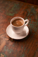 Cup of coffee on rustic wooden background. Soft focus. Copy space	