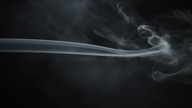 Dark background with swirling white smoke or vapor creating a mysterious and moody atmosphere for creative designs