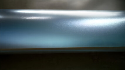 Abstract metallic surface with blue and silver reflections and light streaks