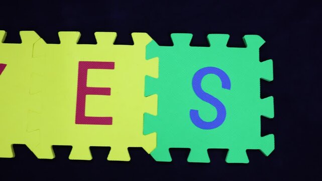 positivity and affirmation word yes on contrasting puzzle pieces