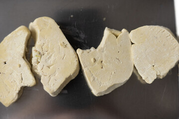 Close-up of Raw, Uncooked Foie Gras Lobe or Goose Liver on a Cutting Board in a Professional or Gourmet Kitchen, Ready for Culinary Preparation