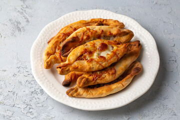 Dishes from traditional Turkish cuisine; Mini pide with cheese - Turkish name; Peynirli mini pide