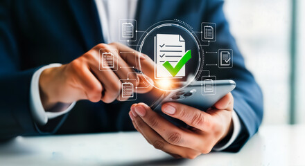 Businessman using a smartphone to review a digital document with a green checkmark, symbolizing approval and successful completion of a task, with holographic icons representing data and workflow