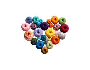 A pile of colorful fashion buttons mixed with blue, green, yellow and red beads on a white background.
