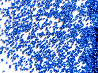 plastic masterbatch, blue masterbatch granules as virgin polymer resin pigment, poured into white background media, suitable for industrial plastic company profile product catalog design