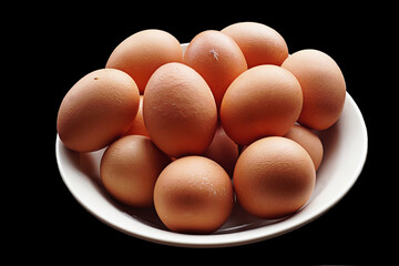 Fresh organic chicken eggs from sustainable natural farm on black background