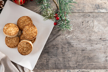 Traditional Spanish mantecados dessert or Christmas shortbread cookies on wooden table. Traditional christmas spanish dessert