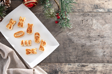 Traditional Spanish marzipan with christmas decorating o wooden table