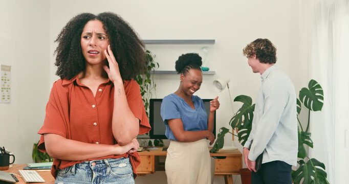 Upset Woman Feels Excluded While Happy Colleagues Laugh and Chat at the Office