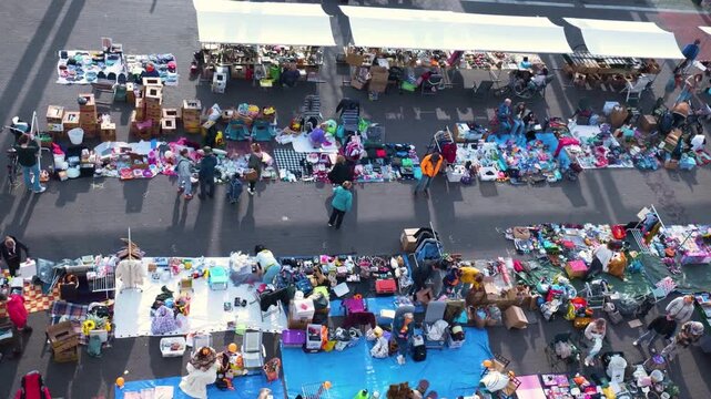 High Angle Shot of People Browsing Colorful Second-Hand Goods at a Sunny Community Fair