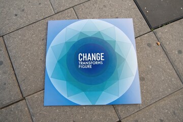 Overhead view of a blue card featuring gradient circle and change text