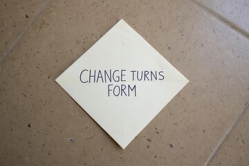 Paper square rotated like diamond with CHANGE TURNS FORM message