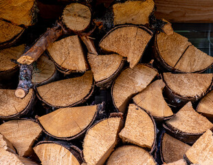 Split firewood is stacked in close-up.