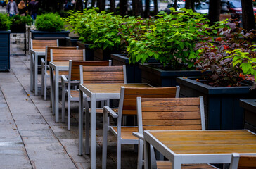 Wooden tables and chairs in a summer cafe.