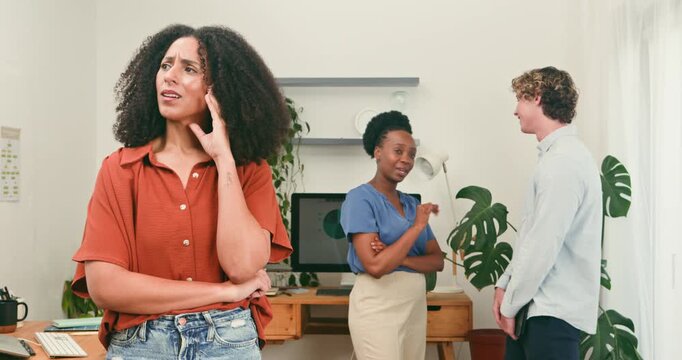Anxious Woman Observes Colleagues Engaged in a Business Discussion at the Office