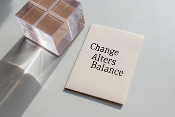 White card with the phrase Change Alters Balance next to a clear block