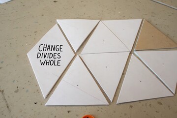 White triangles forming hexagon breaking apart with change message