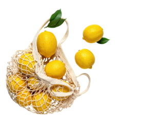 Bright yellow lemons spilling out of a reusable mesh bag with green leaves. Isolated on black