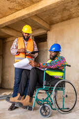 Disability and inclusion, Two African construction engineers collaborate on a project inside a building site, one seated in a wheelchair showcasing teamwork and innovation