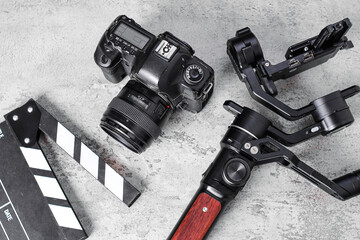 Professional Content Creator Gear With Camera, Gimbal Stabilizer, And Clapperboard