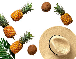 Tropical fruit and sun hat arranged against a black background suggesting summertime