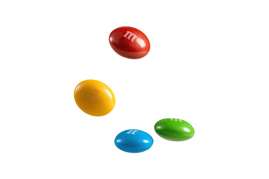 Colorful candies floating against a black background