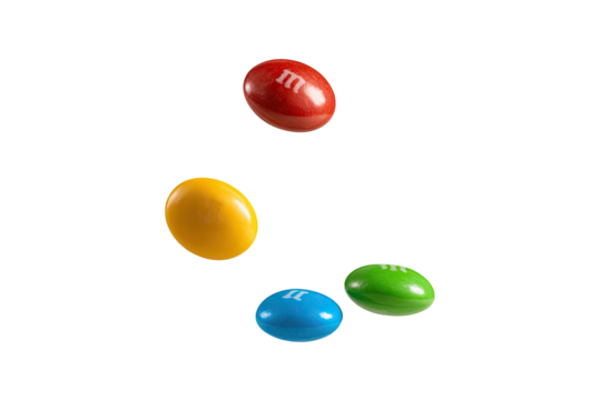 Colorful candies floating against a black background