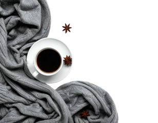 A cup of coffee, star anise, and cozy gray knitwear create a warm, inviting scene