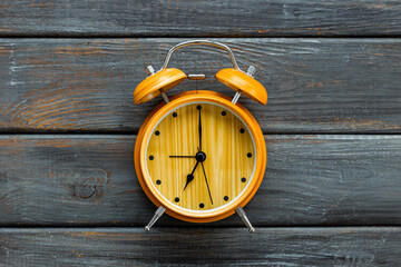 Vintage wooden alarm clock with bells at seven o'clock. Morning routine. In time concept