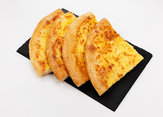 Golden Baked Georgian Khachapuri Slices on Slate Board, Fresh and Crusty, Perfect Sharing Snack