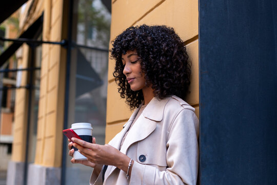 Young woman checking smartphone, enjoying city urban lifestyle - Powered by Adobe