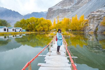 The Tourist woman on the autumn trees on Hushe valley and Gasherbrum glacier in the karakoram mountains range