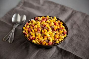 Fruity Kids Breakfast Cereal with Milk in a Bowl, side view.