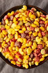 Fruity Kids Breakfast Cereal with Milk in a Bowl, top view.