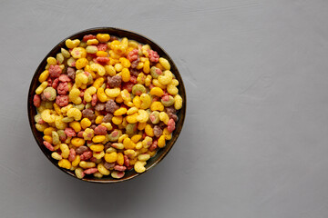 Fruity Kids Breakfast Cereal with Milk in a Bowl, top view. Copy space.